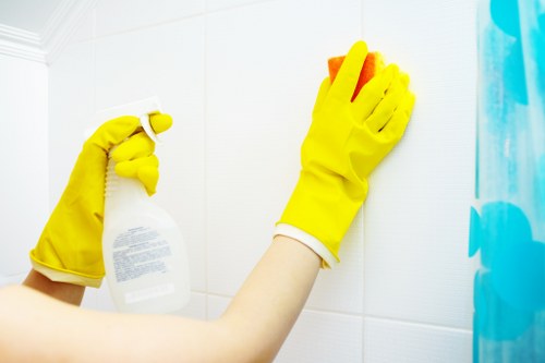 Trained carpet cleaner using professional equipment in a home